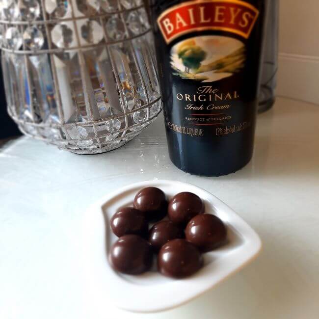 Baileys chocolate truffles nect to a bottle of Baileys liquer. From Luxury Chocolate Drawer Box 