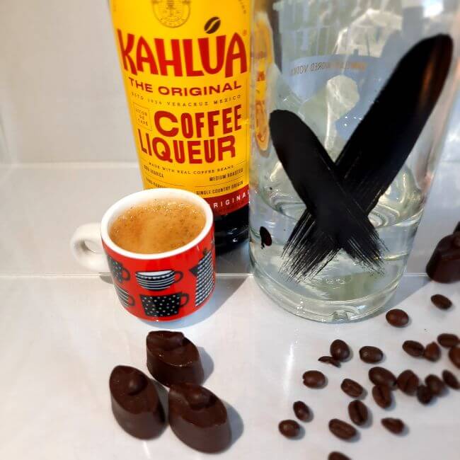 Espresso martini chocolate truffles next to a shot of coffee, Kahlua coffee liquer and vodka. From Luxury Chocolate Drawer Box 